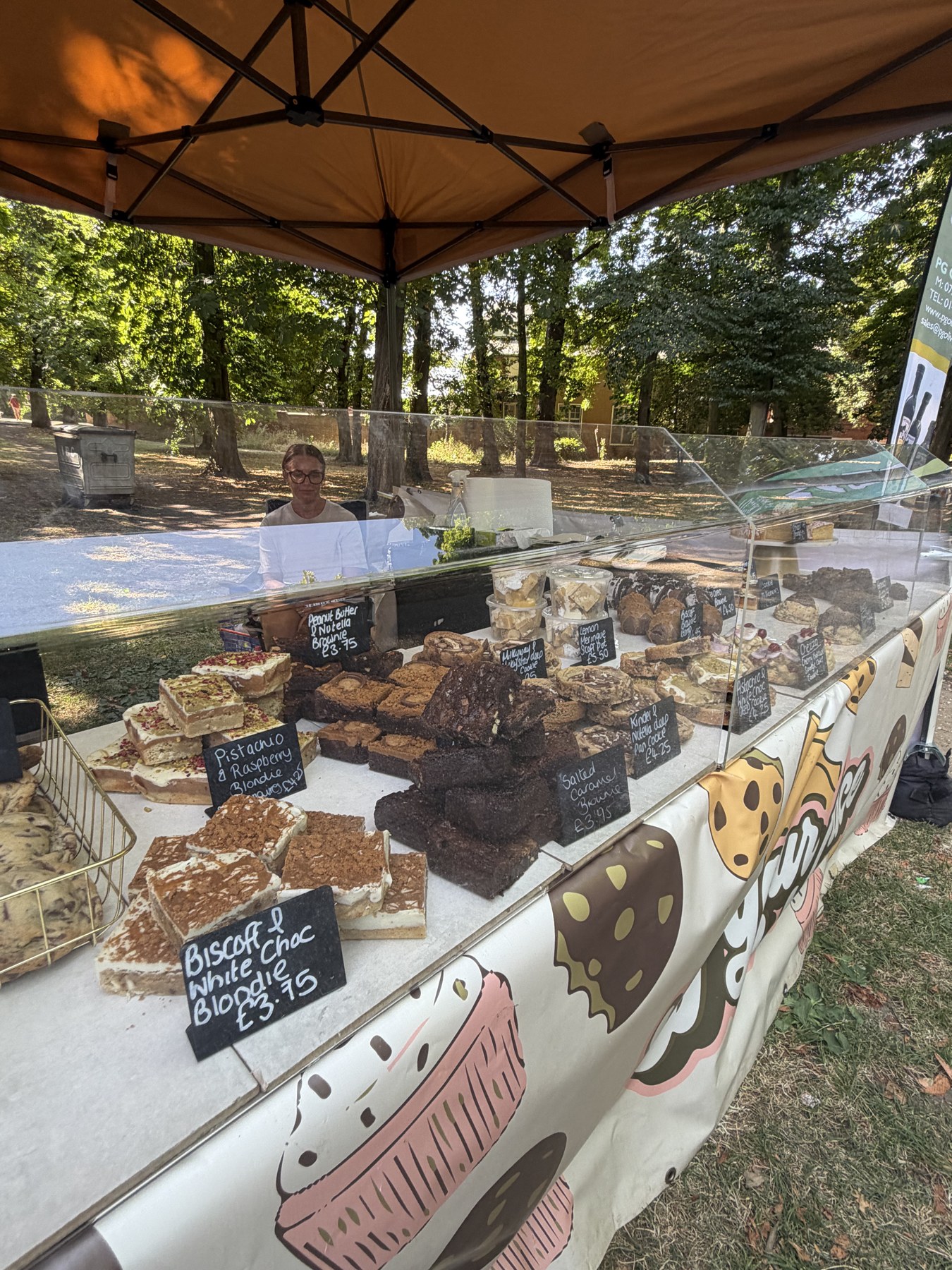 A selection of cakes and sweet bakes at a market stall