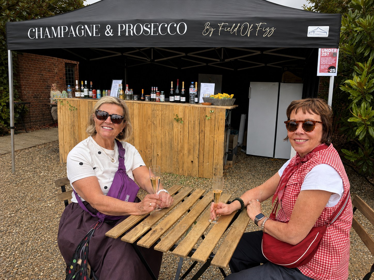 Two smiling visitors enjoying drinks at the Craft Show