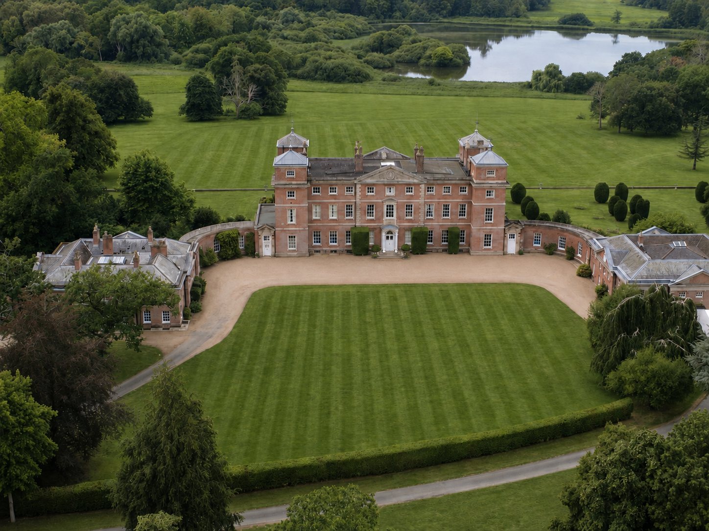 Aerial view of Kimberley Hall with green lawns and the lake beyond