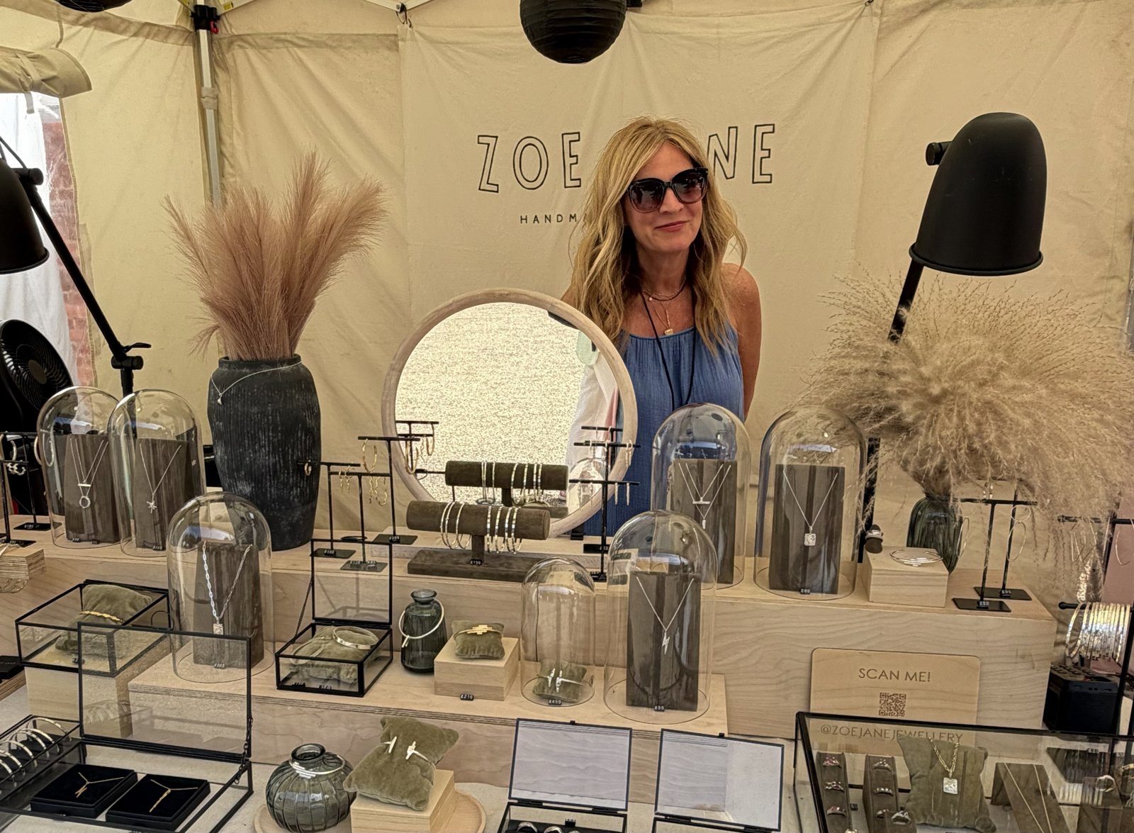 A jewellery maker behind her display of handcrafted jewellery