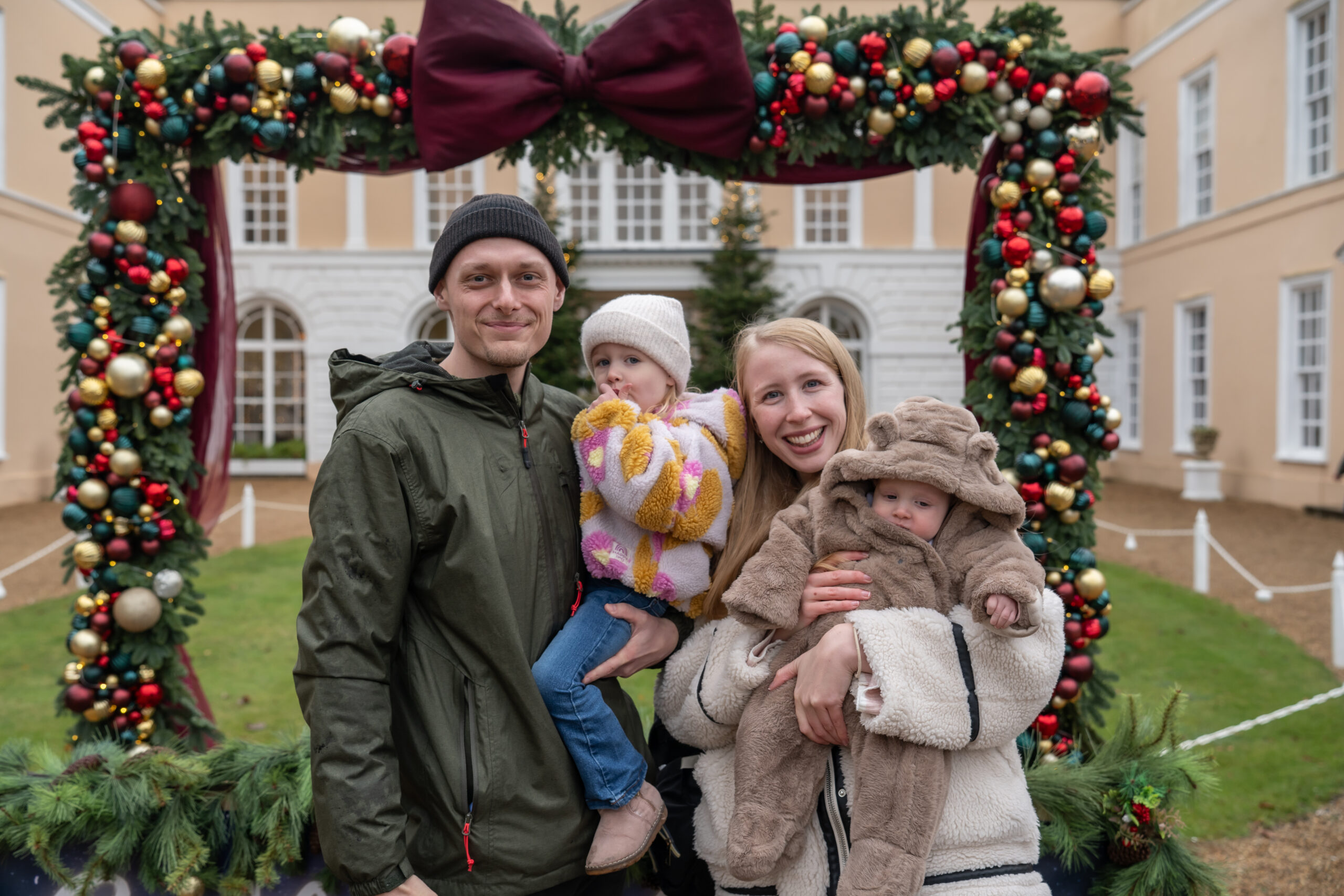 A family posing in the festive photo frame at Suffolk County Christmas Fair