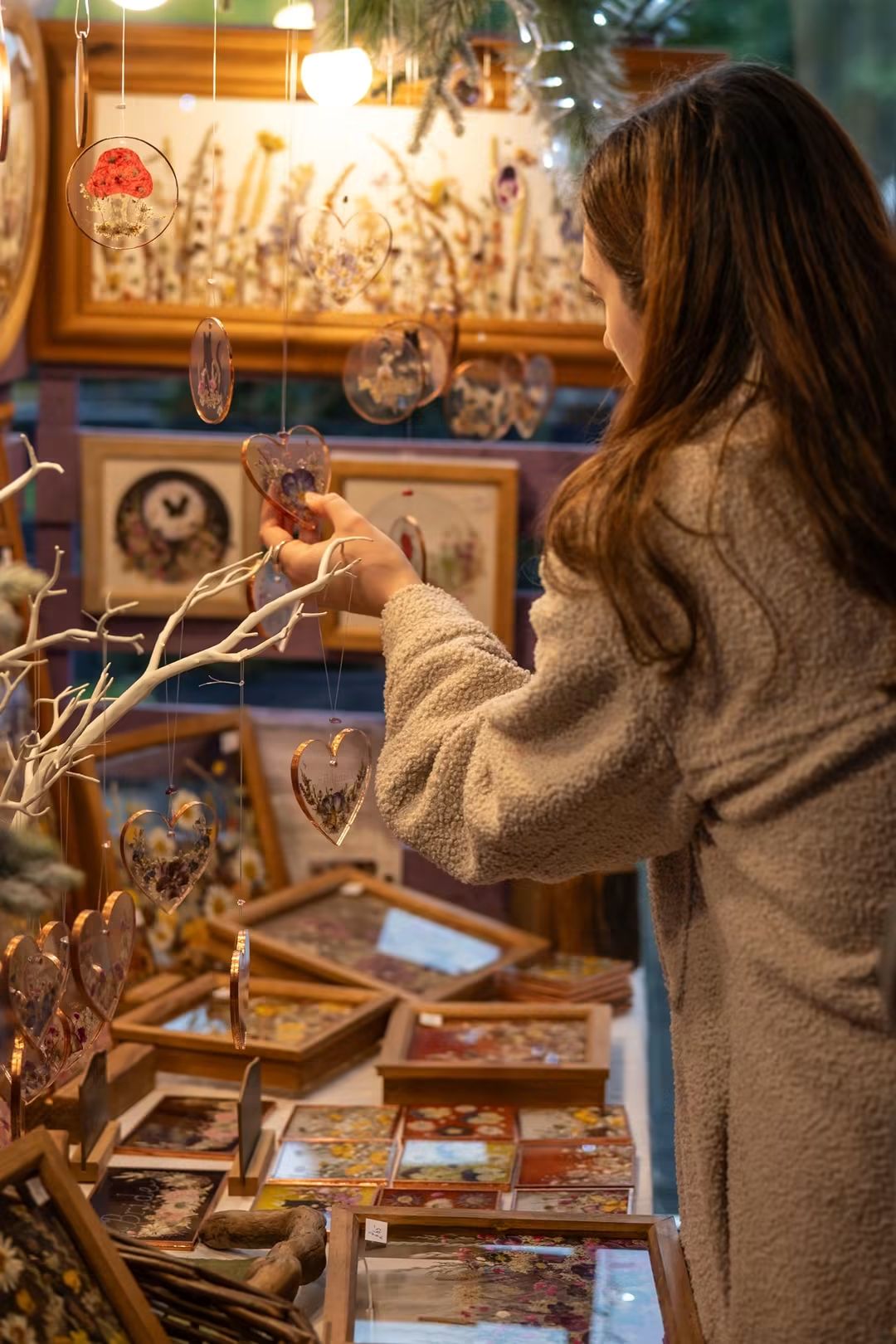 A shopper admiring handmade decorations at the Christmas fair