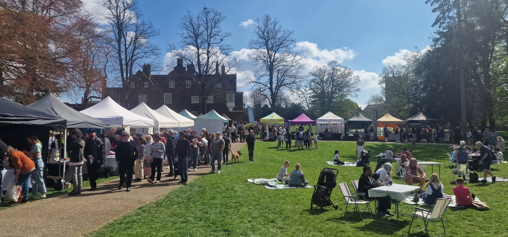 Busy Christchurch Park Market with Christchurch Mansion in the background