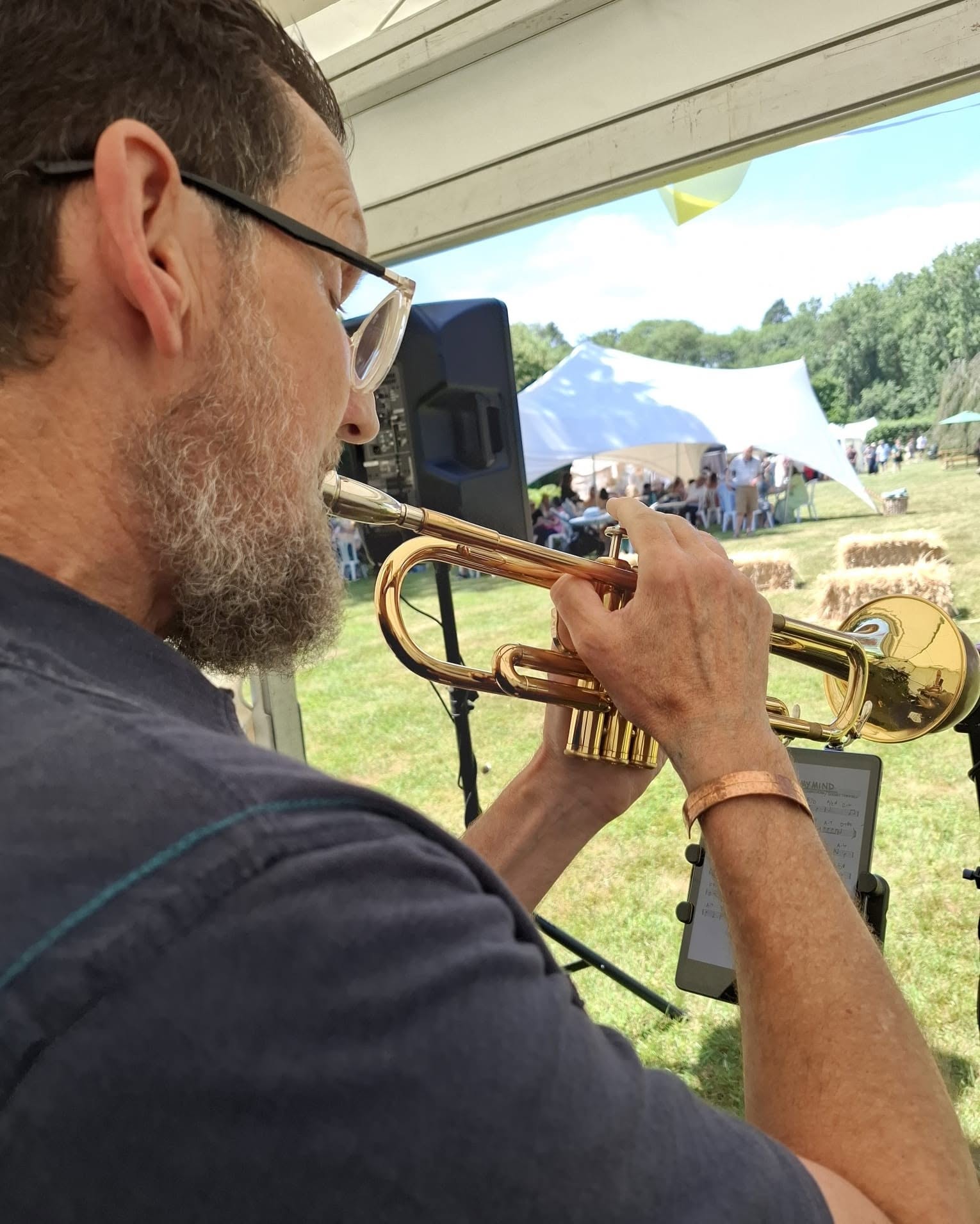 A trumpet player from The Crafty Jazzers performing at the fair